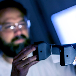 Worker in safety glassess looking at object